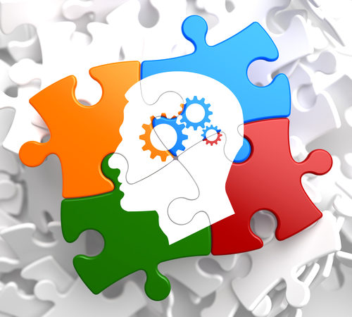 Psychological Concept - Profile Of Head With Cogwheel Gear Mechanism Located On Multicolor Puzzle.